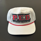 White cap with 'P.E.D. Performance Enhancing Drip' text on a dark background