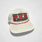 White cap with 'P.E.D. Performance Enhancing Drip' text on a white background